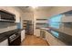 Updated kitchen with stainless steel appliances, granite countertops, and white cabinetry at 5200 Brosche Rd, Orlando, FL 32807