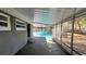 Screened-in patio overlooking a sparkling pool, offering a seamless transition between indoor and outdoor living spaces at 5200 Brosche Rd, Orlando, FL 32807