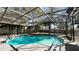 Inviting in-ground pool surrounded by a screened enclosure, creating a private backyard oasis for relaxation at 5200 Brosche Rd, Orlando, FL 32807