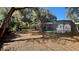 Backyard featuring a screened-in pool, foliage, and a gray house exterior at 5200 Brosche Rd, Orlando, FL 32807
