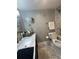 Bathroom featuring vanity with marble countertop, patterned tile floor, and classic fixtures at 5337 Indian Creek Dr # C-4-1, Orlando, FL 32811