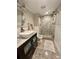 Charming bathroom with vessel sink, stylish vanity, and a frameless glass shower with elegant tile at 5337 Indian Creek Dr # C-4-1, Orlando, FL 32811