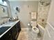 Elegant bathroom featuring marble tile, dark vanity, and modern fixtures at 5337 Indian Creek Dr # C-4-1, Orlando, FL 32811