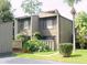Inviting condo featuring a quaint landscape and a charming wood facade at 5337 Indian Creek Dr # C-4-1, Orlando, FL 32811