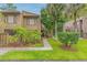 Inviting condo featuring a quaint walkway, lush landscaping, and a charming wood facade at 5337 Indian Creek Dr # C-4-1, Orlando, FL 32811