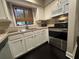 This cozy kitchen features white cabinets, modern appliances, and a window for natural light at 5337 Indian Creek Dr # C-4-1, Orlando, FL 32811