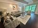 Inviting living room featuring a comfortable sofa, stylish armchairs, and a sliding glass door to a balcony at 5337 Indian Creek Dr # C-4-1, Orlando, FL 32811