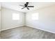 A bright bedroom is enhanced by its ceiling fan, wood-look floor, and natural lighting at 5604 7Th Se St, Lakeland, FL 33812