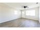 Bright living room with neutral walls, modern ceiling fan and beautiful wood-look flooring at 5604 7Th Se St, Lakeland, FL 33812