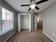 Bedroom features carpet flooring, a ceiling fan, and a closet with bi-fold doors at 607 Kissimmee Ln, Kissimmee, FL 34759
