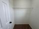 Walk-in closet with carpet flooring and a shelf for storing clothes and accessories at 607 Kissimmee Ln, Kissimmee, FL 34759