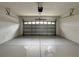 Spacious garage with painted floor and overhead door opener at 607 Kissimmee Ln, Kissimmee, FL 34759