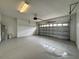 Well-lit garage featuring finished floor, overhead door opener, and ample space at 607 Kissimmee Ln, Kissimmee, FL 34759