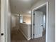 Hallway with neutral walls and carpet flooring provides access to the bedrooms at 607 Kissimmee Ln, Kissimmee, FL 34759