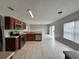 Bright kitchen features wood cabinets, stainless steel appliances, tile flooring, and an open layout to the living area at 607 Kissimmee Ln, Kissimmee, FL 34759