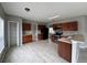 Spacious kitchen with stainless steel appliances, tile floors, plentiful cabinets, and easy access to an adjacent room at 607 Kissimmee Ln, Kissimmee, FL 34759