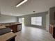 The kitchen features tile flooring, dark cabinets, stainless steel appliances, and large windows for natural light at 607 Kissimmee Ln, Kissimmee, FL 34759