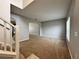 View of the Living Room with neutral walls and carpet with an archway into an adjoining room at 607 Kissimmee Ln, Kissimmee, FL 34759