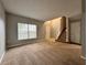View of the Living Room with a staircase and neutral colored walls and carpet with natural light shining in at 607 Kissimmee Ln, Kissimmee, FL 34759