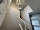 The staircase offers neutral paint and a light fixture at the top of the landing that provides ample lighting at 607 Kissimmee Ln, Kissimmee, FL 34759