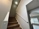 Carpeted staircase with white railing leading to the second floor at 607 Kissimmee Ln, Kissimmee, FL 34759