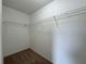 Walk-in closet showcasing neutral walls, carpeting, and metal storage shelving for organized storage at 607 Kissimmee Ln, Kissimmee, FL 34759