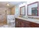 Updated bathroom featuring double sink vanity, granite countertops, tiled shower, and natural light at 7614 Lake Dr, Belle Isle, FL 32809