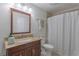 Bathroom featuring vanity, granite countertops, large mirror, and shower and tub combo at 7614 Lake Dr, Belle Isle, FL 32809