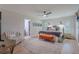 Spacious main bedroom with ceiling fan, natural light, modern decor, seating and en suite bathroom at 7614 Lake Dr, Belle Isle, FL 32809