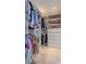 Walk-in closet with custom shelving, hanging rods, drawers for optimal storage and organization at 7614 Lake Dr, Belle Isle, FL 32809