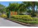 Community sign for Wind Harbor surrounded by manicured landscaping and mature trees at 7614 Lake Dr, Belle Isle, FL 32809
