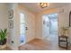 Welcoming entryway featuring hardwood floors, a modern light fixture, and views into the hallway at 7614 Lake Dr, Belle Isle, FL 32809