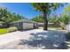Attached garage with a wide driveway, mature trees, and a landscaped yard at 7614 Lake Dr, Belle Isle, FL 32809