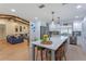 Modern kitchen featuring stainless steel appliances, granite countertops, and a large center island with bar seating at 7614 Lake Dr, Belle Isle, FL 32809