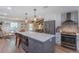 Eat-in kitchen featuring a large island with an oven, stainless steel refrigerator, and modern appliances at 7614 Lake Dr, Belle Isle, FL 32809