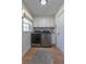 Bright laundry room with front load washer/dryer, storage cabinets, natural light and modern finishes at 7614 Lake Dr, Belle Isle, FL 32809