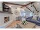Inviting living space with a brick fireplace, hardwood floors, stylish seating, and an open concept design at 7614 Lake Dr, Belle Isle, FL 32809
