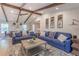Spacious living room with vaulted ceilings, wood beams, stylish decor, and a comfortable seating arrangement at 7614 Lake Dr, Belle Isle, FL 32809