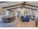 Bright open-concept living space with vaulted ceilings, wooden beams and a large blue sofa at 7614 Lake Dr, Belle Isle, FL 32809