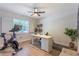 Bright home office with natural light, hard wood floors, modern desk, and ample workspace at 7614 Lake Dr, Belle Isle, FL 32809