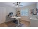 Bright home office with natural light, hard wood floors, modern desk, and ample workspace at 7614 Lake Dr, Belle Isle, FL 32809