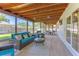 Enclosed porch featuring comfortable seating and backyard views at 7614 Lake Dr, Belle Isle, FL 32809