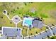 Overhead view of community pool, parking and playground surrounded by green space and paved walkways at 780 Livestock Loop, St Cloud, FL 34771