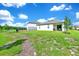 Expansive backyard featuring a tranquil pond view, lush grass, and a patio, perfect for relaxing and entertaining guests at 780 Livestock Loop, St Cloud, FL 34771