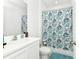 Bright bathroom featuring seashell themed shower curtain and a vanity at 780 Livestock Loop, St Cloud, FL 34771