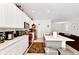 Bright and airy kitchen with white cabinets, quartz countertops, stainless steel appliances and decorative rooster accents at 780 Livestock Loop, St Cloud, FL 34771