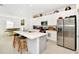 Modern kitchen with sleek stainless steel appliances, a quartz island, and ample cabinet space at 780 Livestock Loop, St Cloud, FL 34771