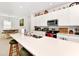 Bright kitchen with white quartz countertops, stainless steel appliances, and an open layout to the dining area at 780 Livestock Loop, St Cloud, FL 34771