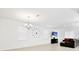 Open-concept living space with tile flooring, modern chandelier, and large windows for natural light at 780 Livestock Loop, St Cloud, FL 34771