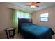Bedroom with bed and leafy green curtains creating a relaxing atmosphere at 7813 Arabian Pl, Orlando, FL 32818